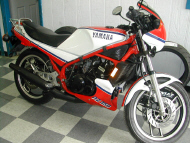 Red Yamaha motorcycle parked inside a service department 